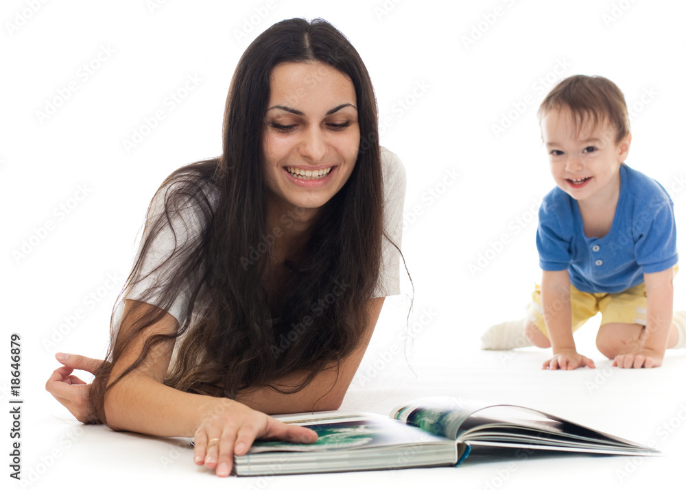 Young mother reading book on floor with her son Young mother reading book on floor with her son