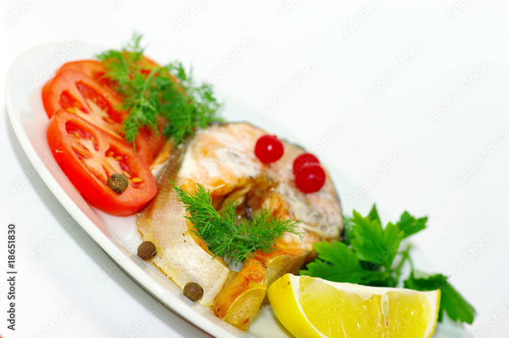grilled fish with vegetables and spices on the white background grilled fish with vegetables and spices on the white background