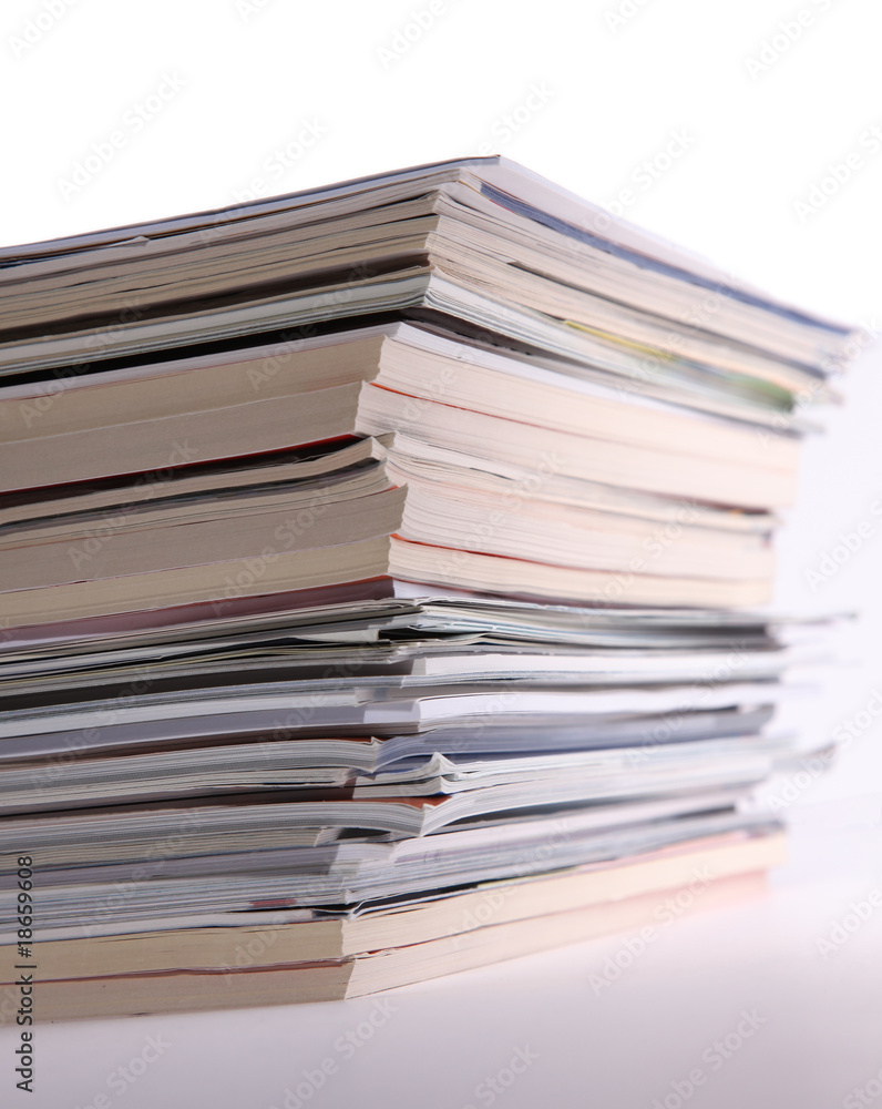 Isolated stack of magazines against white background Isolated stack of magazines against white background