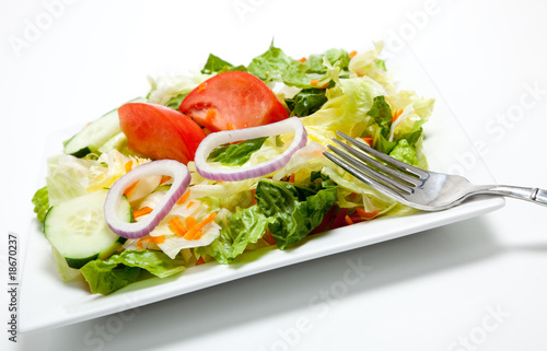 Tossed salad on a plate on a white background