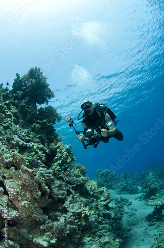 man diving with profesional camera