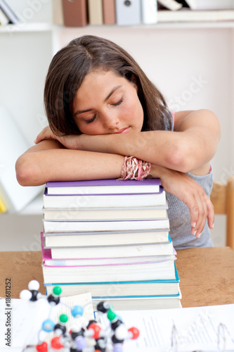 Tired teeenager sleeping in a library photo