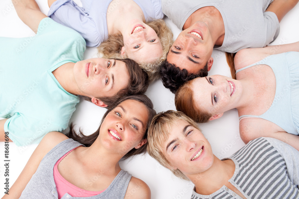 Friends lying on floor with heads together Friends lying on floor with heads together