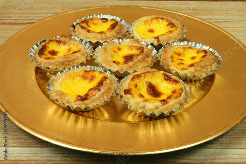 Portuguese egg tarts on golden plate