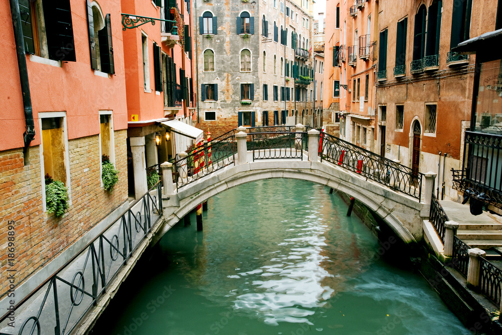 Colorful bridge across canal in Venice, Italy