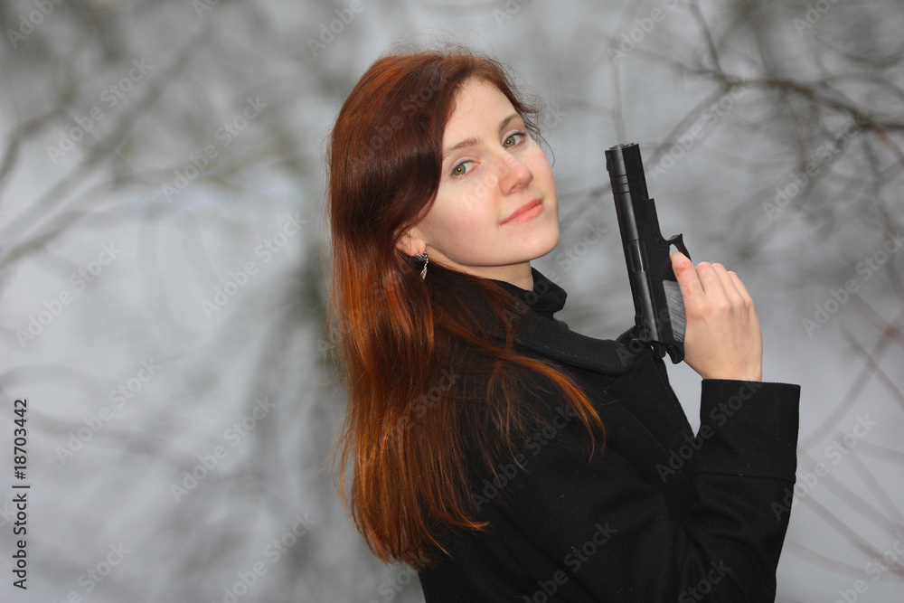 a pretty young woman aiming with the gun a pretty young woman aiming with the gun
