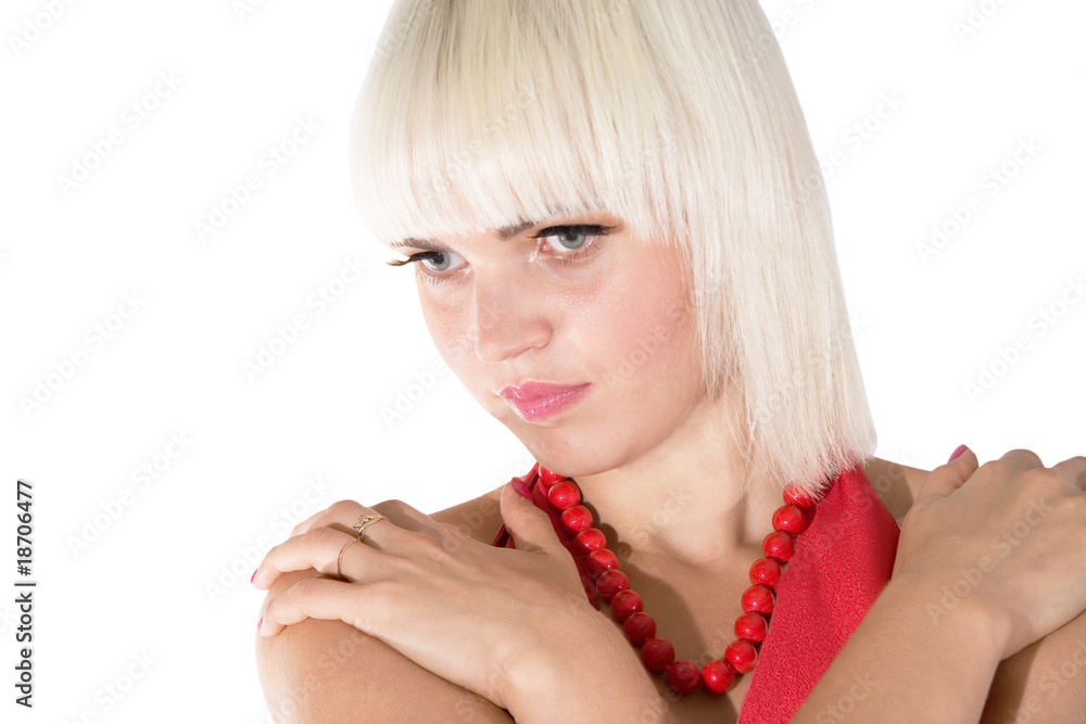 Thoughtful beautiful young blonde girl wearing red beads Thoughtful beautiful young blonde girl wearing red beads