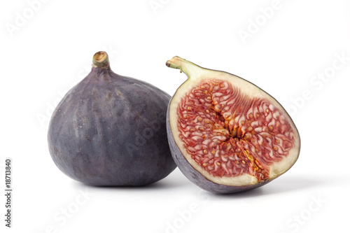 One and a half Fresh figs on white background