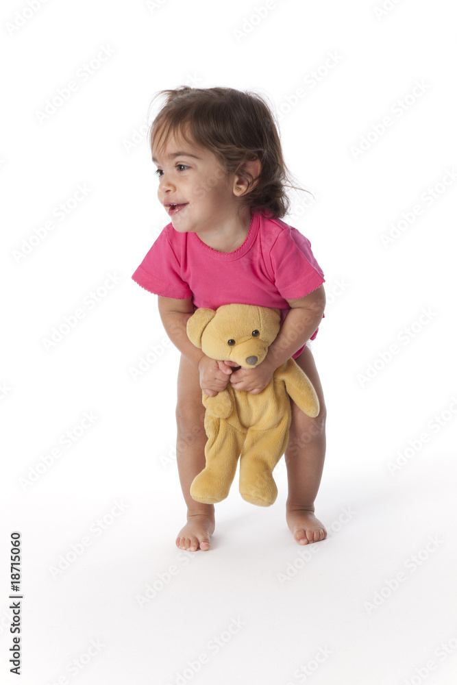 Baby girl holding her toy bear