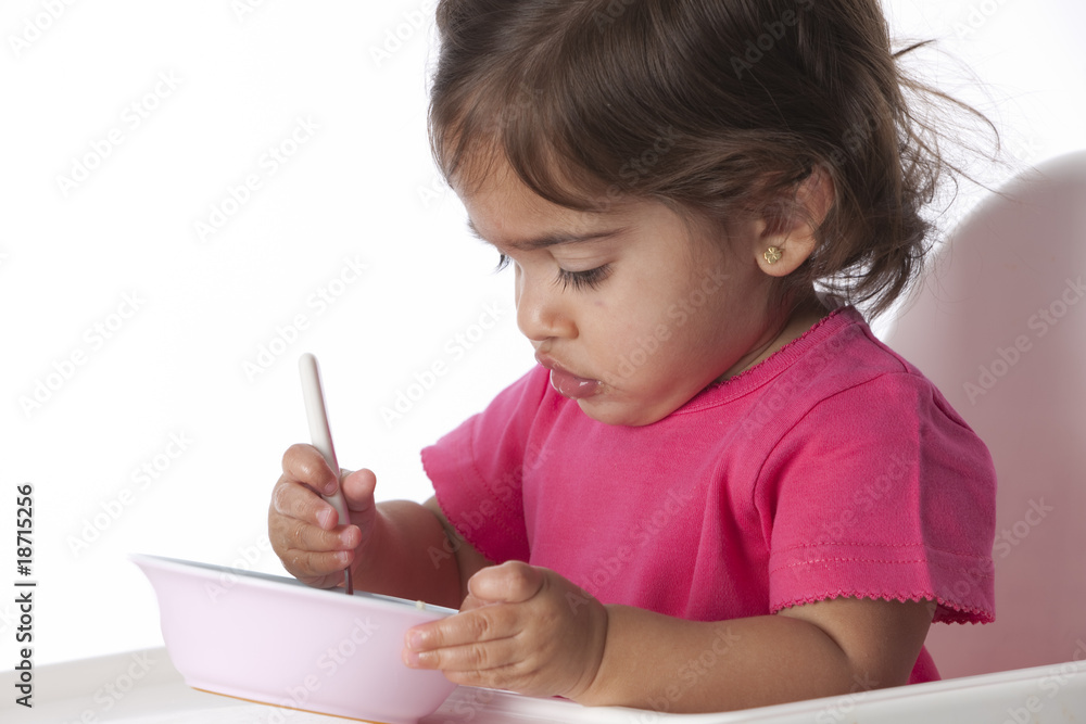 Baby girl is eating by herself Baby girl is eating by herself