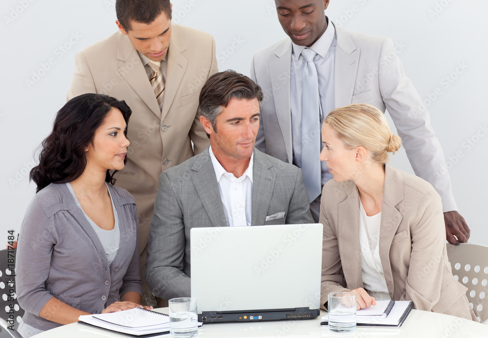 Multi-ethnic business team working in office together Multi-ethnic business team working in office together