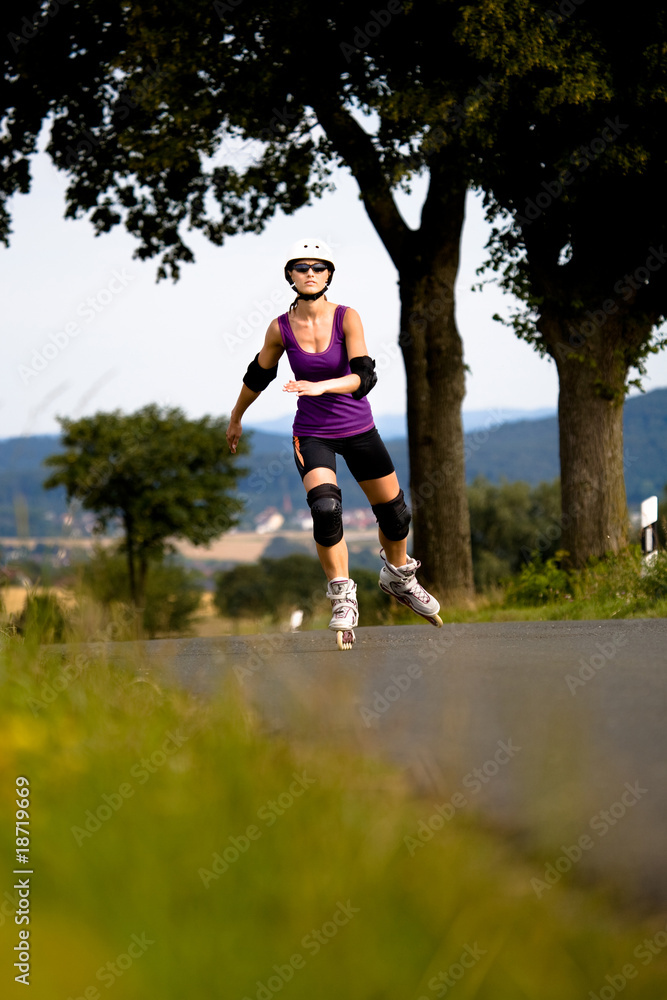 Young woman on rollerblades in the country Young woman on rollerblades in the country