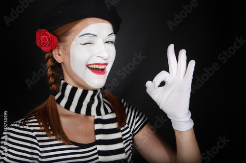 Portrait of a happy mime comedian showing OK photo