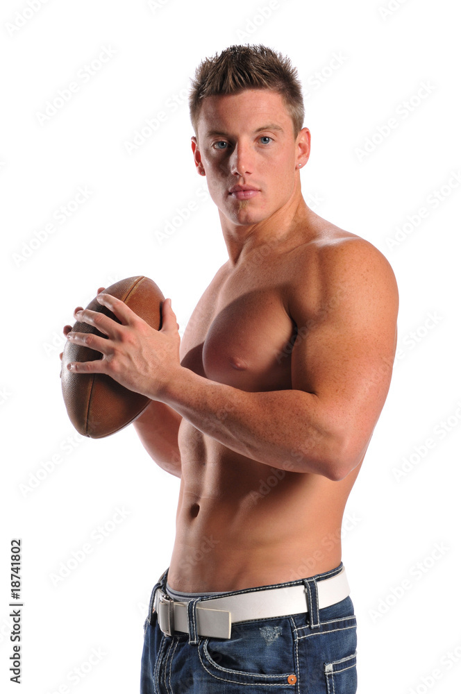 Muscular young man holding a football Muscular young man holding a football