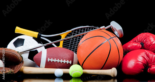 Assorted sports equipment on black