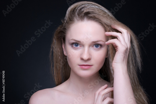 Close up portrait of beautiful blond girl on black