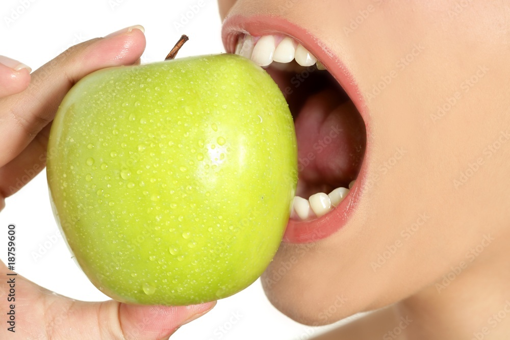 Apple macro on woman mouth detail of bite Apple macro on woman mouth detail of bite