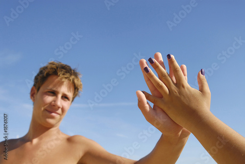 Boy touching a girls hand in a romantic way