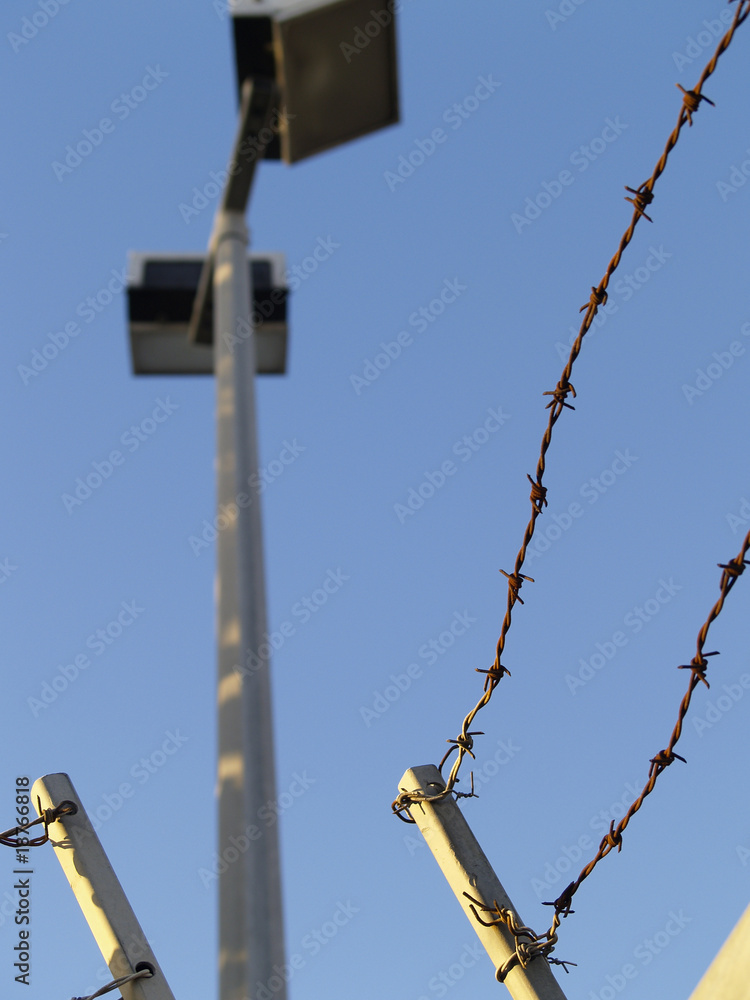 Obraz premium Security fence and lights, focus on fence.
