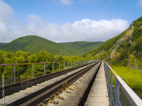 Year landscape with railway line, hills and cloudy sky