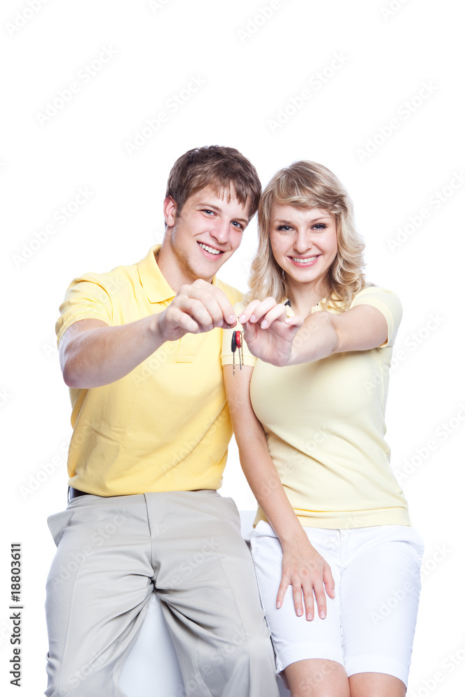 Young couple holding a set of keys Young couple holding a set of keys