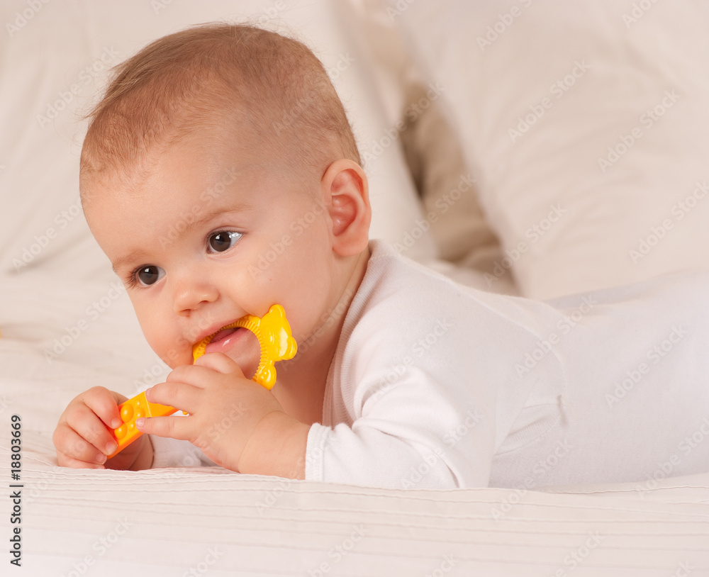 Baby biting with yellow toy Baby biting with yellow toy