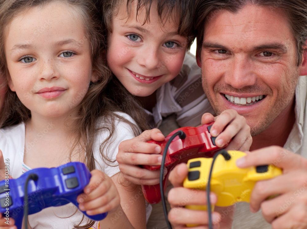 Obraz premium Happy father and his children playing video games