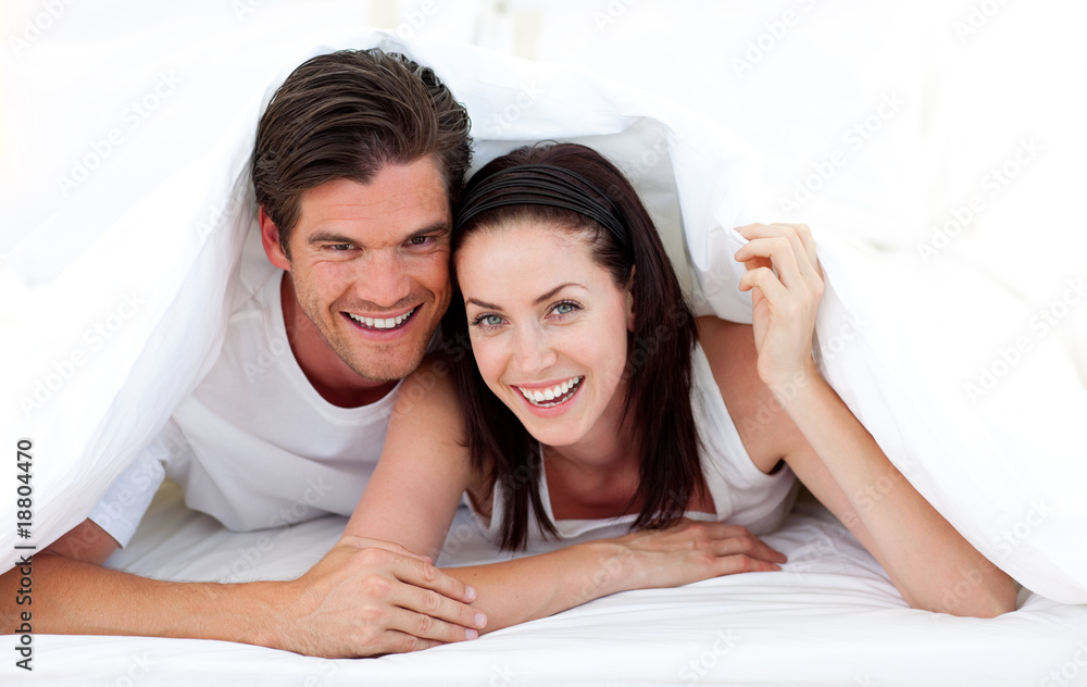 Happy Couple lying on bed Happy Couple lying on bed