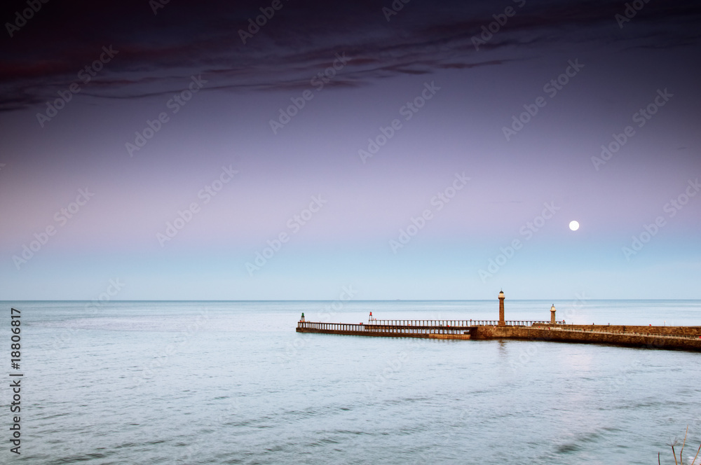 Harbour entrance at Whitby North Yorkshire, UK at moonrise