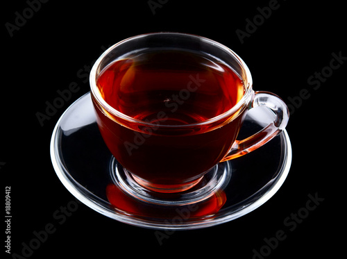 Glass cup of tea isolated on black