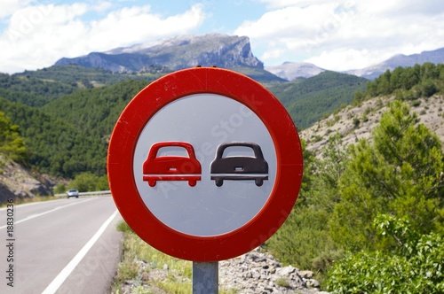 Nostalgic no overtaking traffic sign showing two old cars photo