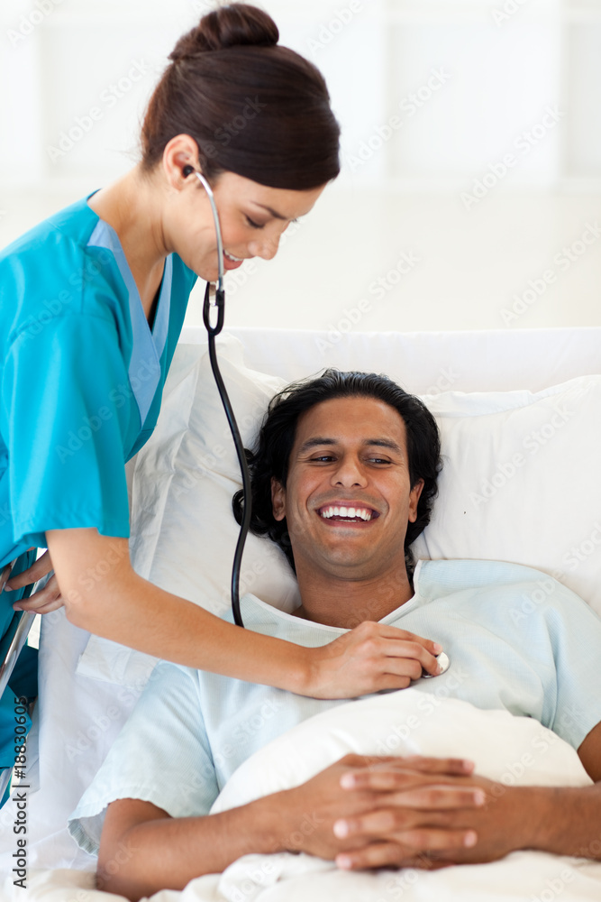 A doctor checking the pulse of a smiling patient A doctor checking the pulse of a smiling patient