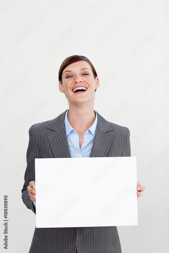 Laughing businesswoman holding white card Laughing businesswoman holding white card