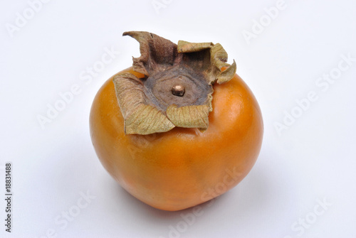 one organic sharon fruit and a white background