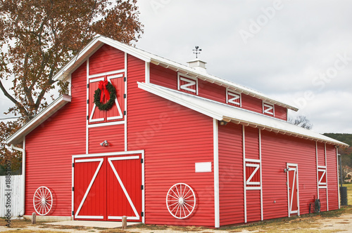 red barn on wintry day decorated for holidays