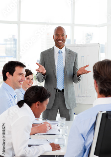 Smiling businessman doing a presentation to his colleagues