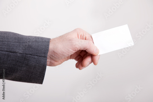 Businessman holding out a blank card