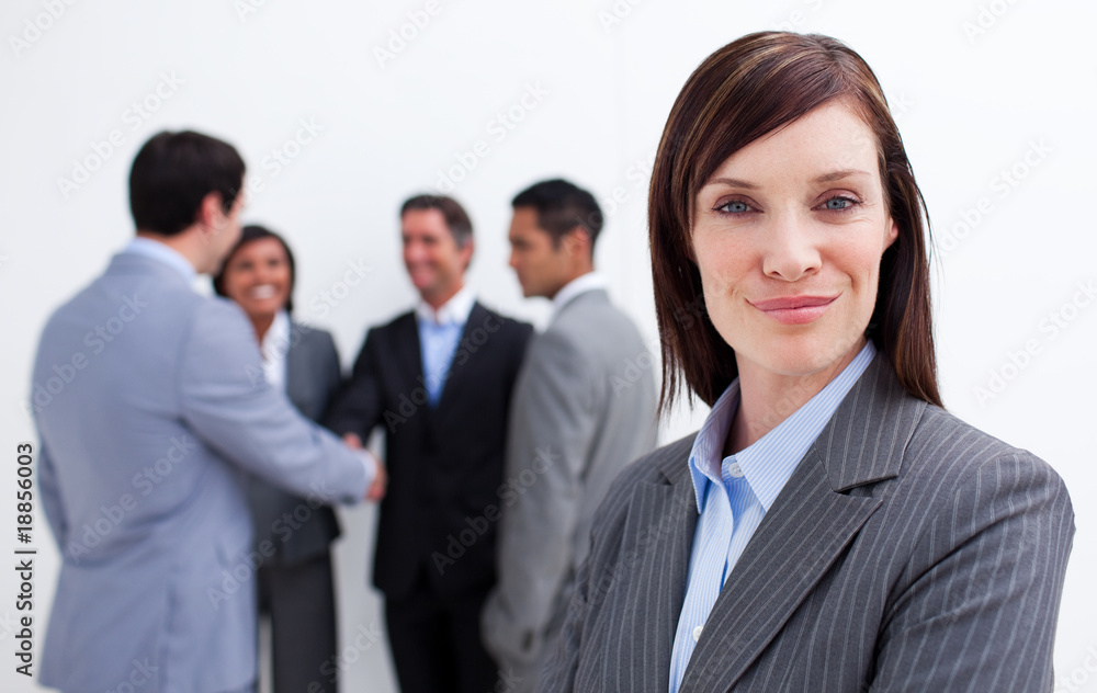 Confident manager with her team in the background Confident manager with her team in the background