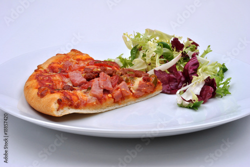 italian pizza with ham  salami and salad