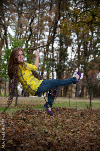 Pretty teen girl on a swing