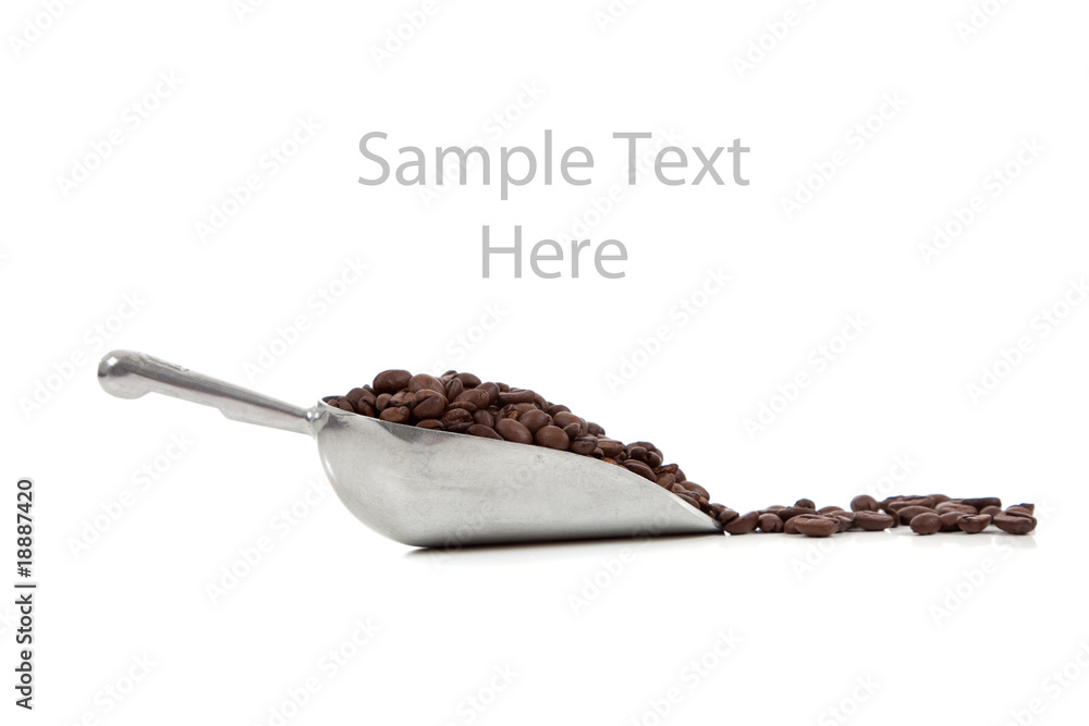 Fototapeta premium A silver scoop with coffee beans on white