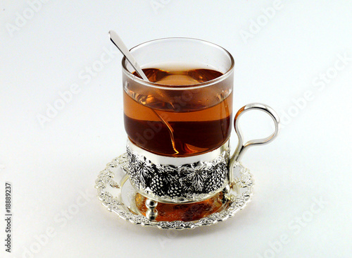 Tea in glass mug and lemons