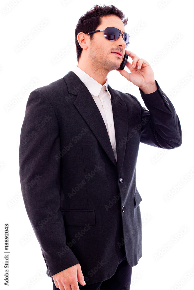 Handsome young business man talking on phone Handsome young business man talking on phone