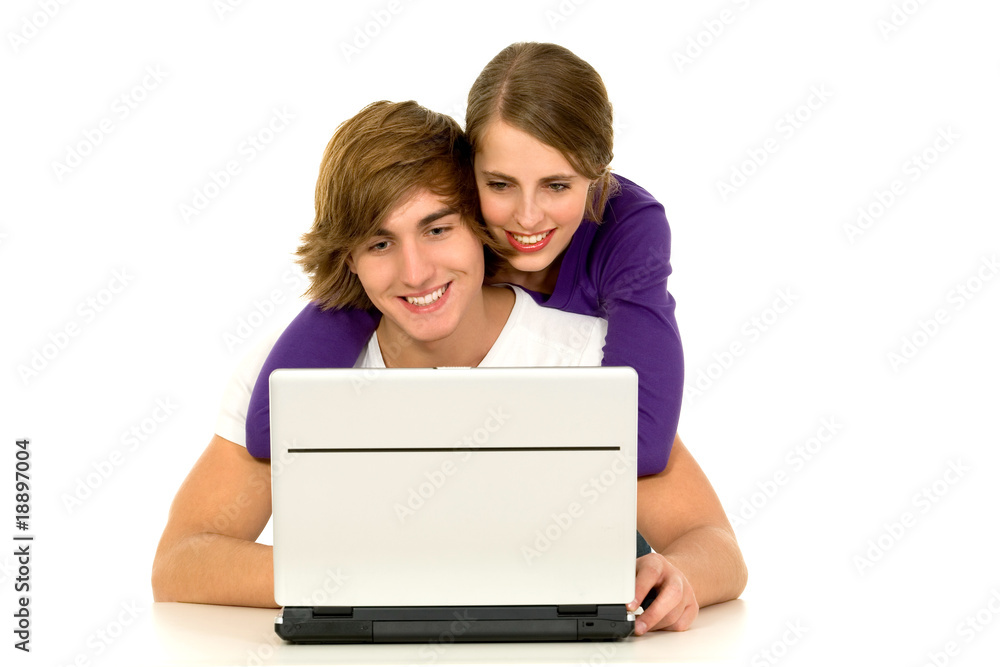 Happy young couple using a laptop computer