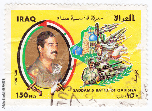 army in Iraq with portrait of Saddam Hussein