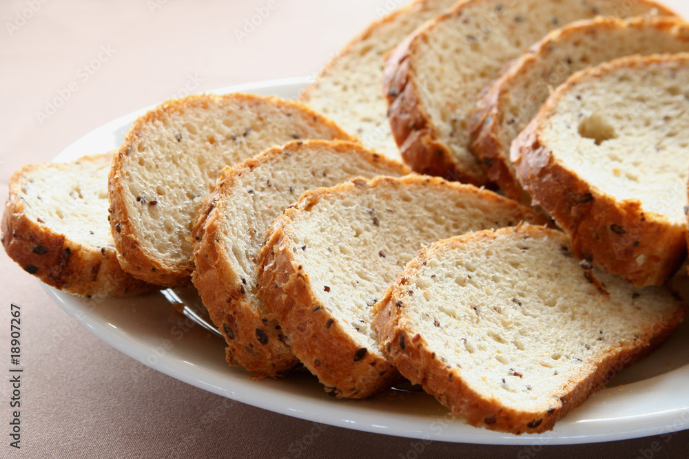Appetizing slices of a white loaf lie on a plate Appetizing slices of a white loaf lie on a plate