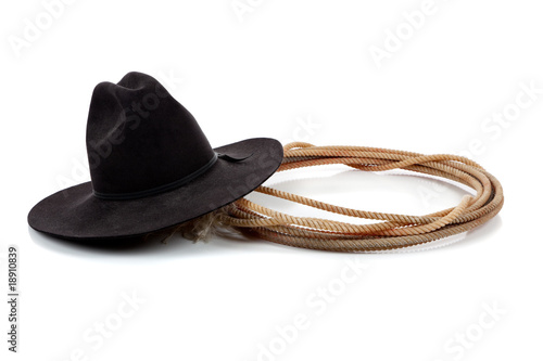 Black cowboy hat and lasso on white