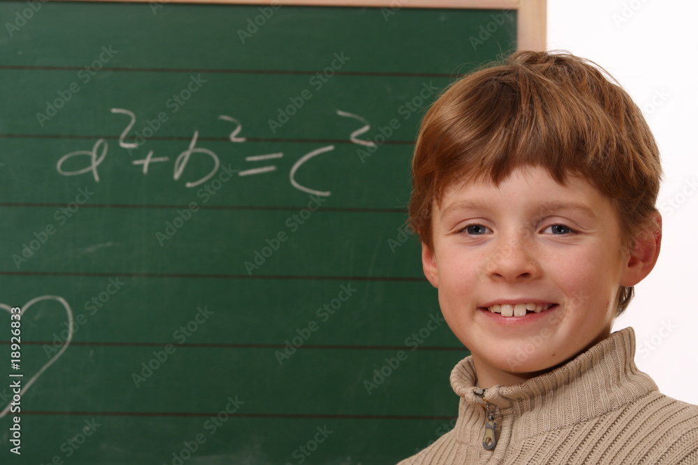 Happy schoolboy at the chalkboard Happy schoolboy at the chalkboard