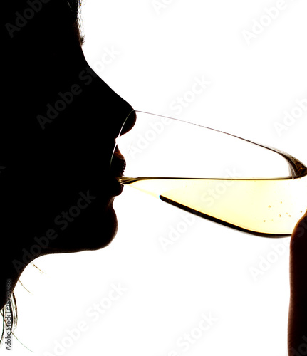 Silhouette of the girl drinking sparkling wine