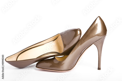 Beige-golden female new varnished shoes on high heel-stiletto